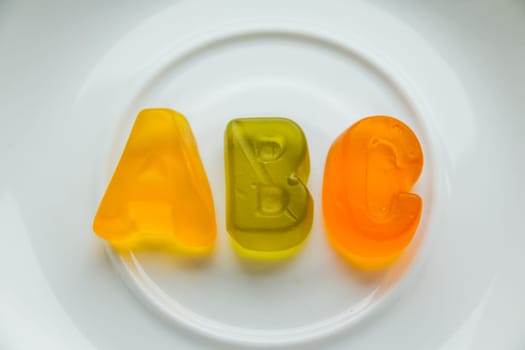 Jelly bean sweets and ABC letters. Education and alphabet concept