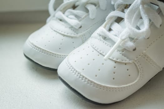 pair of white sport sneaker shoes on black reflective background
