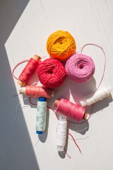 Flat lay composition with sewing threads on color background