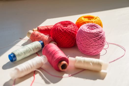 Flat lay composition with sewing threads on color background
