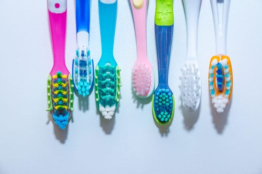 whitening. tooth care. teeth healthy concept. New ultra soft toothbrushes in a row, Dental Industry. various types of toothbrushes.