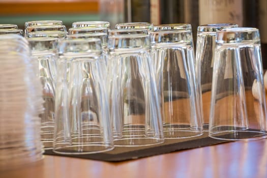 Empty glasses at the bar.Preparing for party. Many clean shiny empty glasses