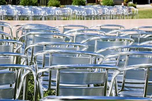 Rows of empty metal chair seats installed for some business event or performance,festival