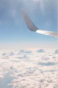 View from airplane, carrier wing and glorious blue sky with beautiful cumulus of white clouds