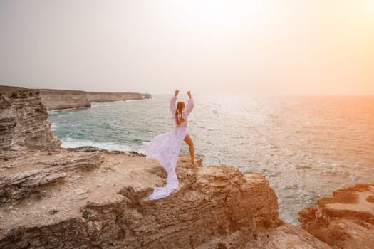 Woman sea white dress. Happy freedom woman on the beach enjoying and posing in white dress. Rear view of a girl in a fluttering white dress in the wind. Holidays, holidays at sea