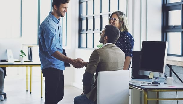 Handshake, meeting and leadership with businesspeople in office for b2b, collaboration or teamwork. Support, happy and deal with employee shaking hands in digital agency for creative, vision or goals.
