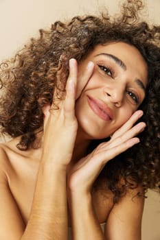 Woman beauty face close-up skin health nails and hair, hair dryer style curly afro hair, body and beauty care concept. High quality photo
