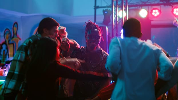 Diverse people waltzing in nightclub, attending cool party with friends at discotheque. Young couples dancing in pairs on romantic music, showing off slow dance moves on dance floor. Tripod shot.