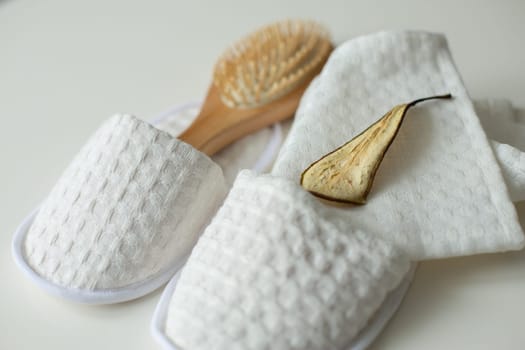 pattern, fabric shoes, shower slippers, massage brush, dried pear, lies on the table