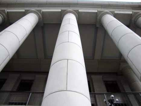 A classic white building with three pillars is a symbol of history and tradition.