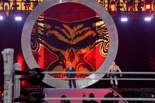 Santa Clara, California - March 29, 2015: WWE Champion Brock Lesnar and his agent Paul Heyman make a grand entrance at Wrestlemania 31, the showcase of the immortals, as night falls over the Levi's Stadium. The crowd cheers loudly for the Beast Incarnate and his advocate, who are ready to face Roman Reigns in the main event of the night. This is a historic moment for Lesnar, who is looking to retain his title and cement his legacy as one of the greatest WWE Superstars of all time.
