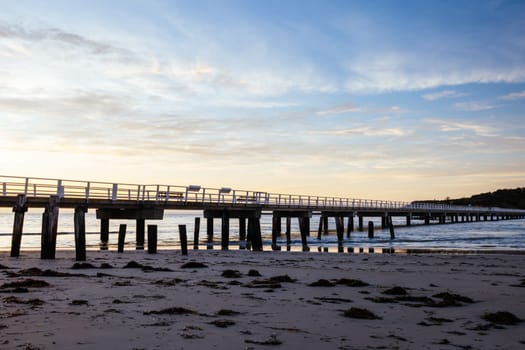 A view of the famous causeway leading to Granite Island Recreation Park at sunrise in Victor Harbor on a sunny autumn day in South Australia, Australia