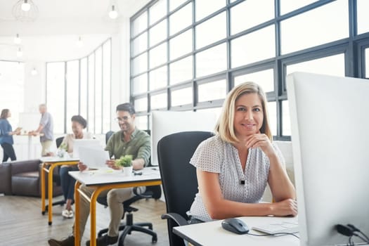 Theres some tools that can make life easy for designers. Portrait of a young designer in an office with her colleagues in the background