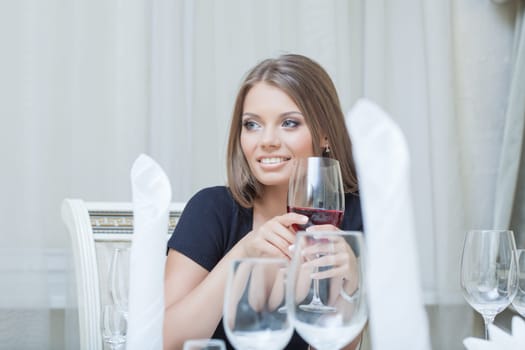 Portrait of beautiful young woman smiling in restaurant