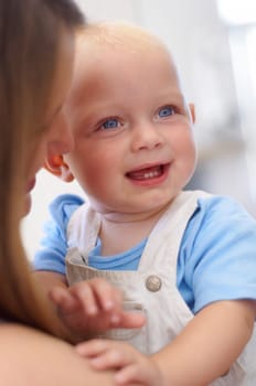 You are so funny mum. Young beautiful mother holding her cute baby