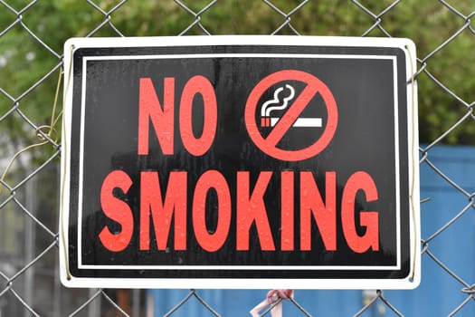 No Smoking Sign on a Construction Fence. High quality photo