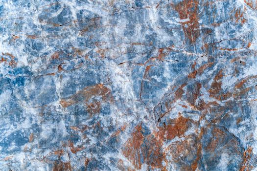 Texture of rusty orange plaque on gray stone slab with white pattern. Top view.