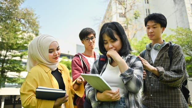 Caring group of university students comforting sad female friend. Friendship, support and youth lifestyle concept.