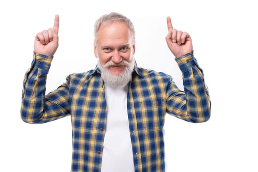 senior pensioner gray-haired man with a beard in a shirt tells the news on a white background.