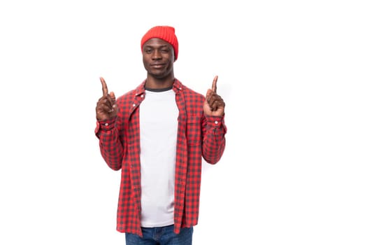 smart young african man in red plaid shirt pointing with index finger at idea over isolated white background.
