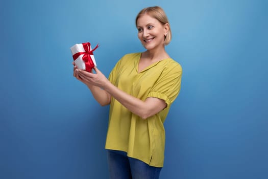 joyful blond middle-aged woman received her birthday present.