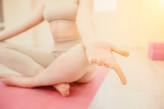 Group of young womans fitness instructor in Sportswear Leggings and Tops, stretching in the gym before pilates, on a yoga mat near the large window on a sunny day, female fitness yoga routine concept.