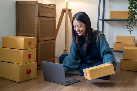 Young happy Asian woman looking at laptop screen, celebrate for sell, smile young entrepreneur happy for sale successful . High quality photo