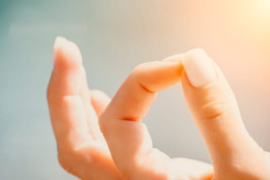 Close up Hand Gesture of Woman Doing an Outdoor Lotus Yoga Position. Close up. Blurred background