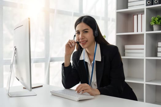 Portrait of smiling woman headset call center operator in office.