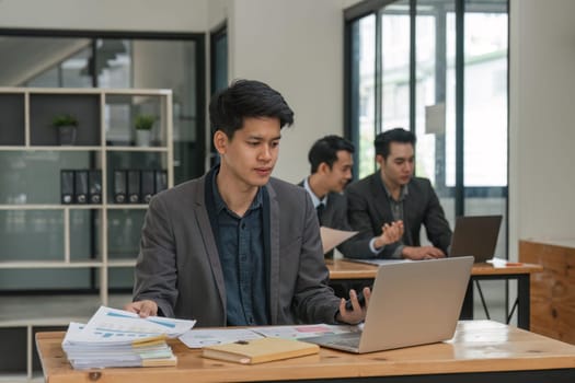 business man sitting in office and working on laptop.