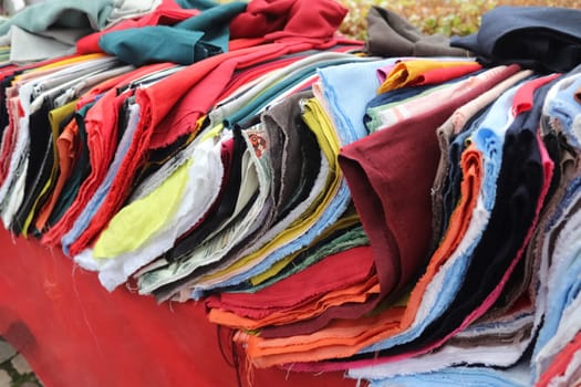 View on samples of cloth and fabrics in different colors found at a fabrics market.