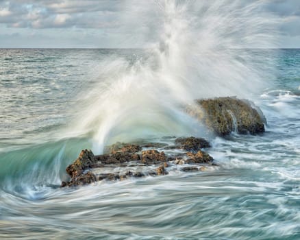 Crashing waves over rocks in the Dominican Republic.