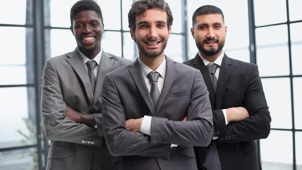 three businessmen crossing their arms looking at camera