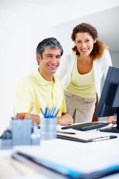 Business people smiling at work. Portrait of two business people smiling at work