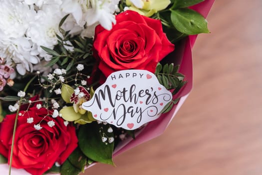 Close up of a beautiful bouquet of roses with a happy mothers day card