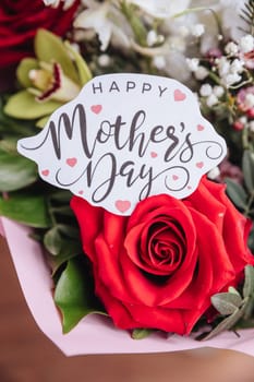 Close up of a beautiful bouquet of roses with a happy mothers day card