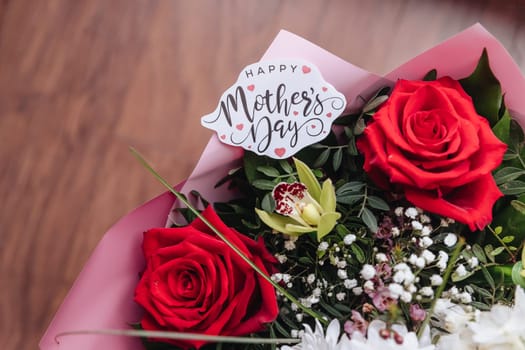 Close up of a beautiful bouquet of roses with a happy mothers day card. Mother's Day concept