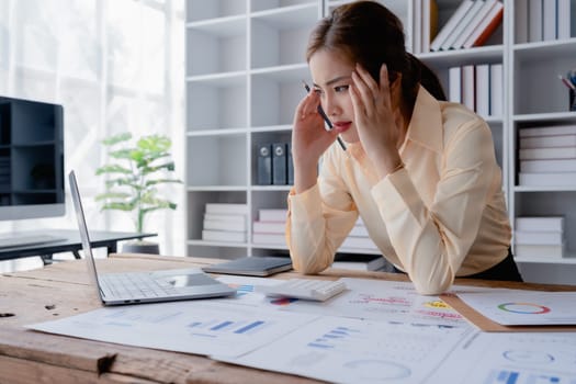 Portrait of business owner, woman using computer and financial statements Anxious expression on expanding the market to increase the ability to invest in business.