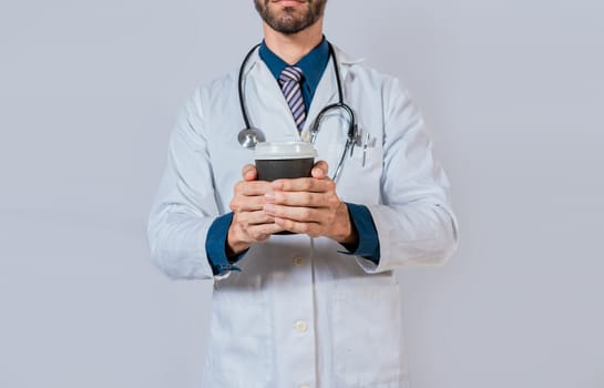 Doctor hands holding paper coffee. Doctor holding takeaway coffee on isolated background, Young doctor holding a coffee to go isolated