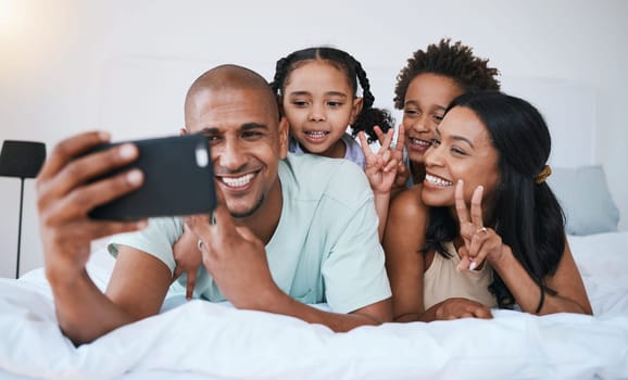 Selfie smile, family and peace sign in bedroom, bonding and relaxing together in home. Bed, photo and children with mother and father taking pictures for happy memory, social media or v hand emoji