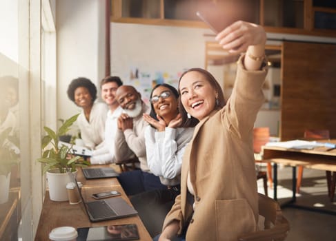 Selfie, friends and memory with a business team working in the boardroom of their corporate workplace. Teamwork, profile picture and startup with a group of people posing for a photograph together.