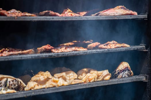 Cabinet for smoking fish. Fresh fish is laid out on the shelves, the process of smoking sea fish. High quality photo