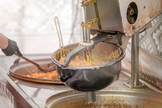 The process of making fresh cookies. Large industrial mixer close-up. She mixes the dough for sweet pastries in a pastry shop. High quality photo