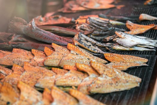 Fish of different varieties are grilled. Fishing season. High quality photo