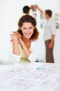 Business woman smiling. Portrait of business woman smiling with colleagues in background