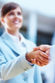 Youve got yourself a deal. two people shaking hands in a corporate environment