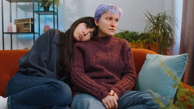 Portrait of sad two lesbian women family couple or girl friends suffers from unfair situation at home. Problem, break up, depressed feeling bad annoyed, burnout, bankruptcy, debt, loan. LGBT people