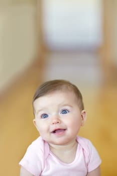 Shes just too cute. Portrait of an adorable baby girl sitting on the living room floor