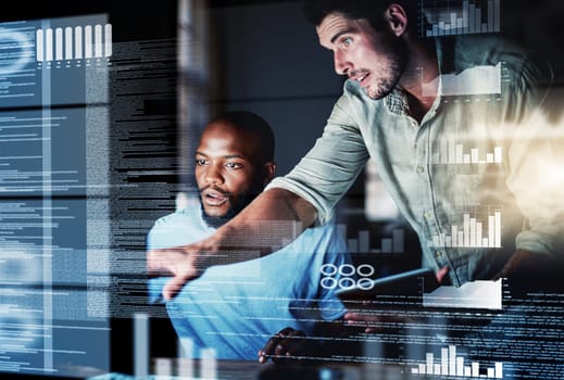 Shot of two programmers working together on a computer code at night.