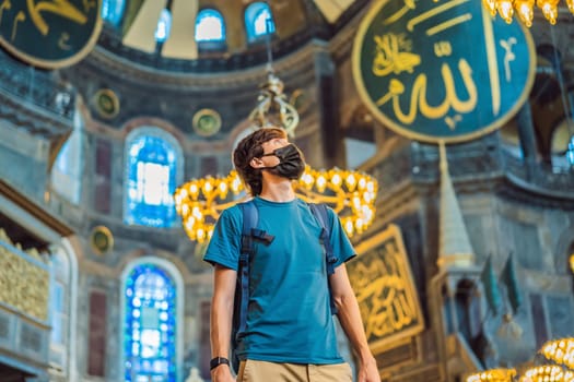 Man tourist enjoying Hagia Sofia, Ayasofya interior in Istanbul, Turkey, Byzantine architecture, city landmark and architectural world wonder. Turkiye.